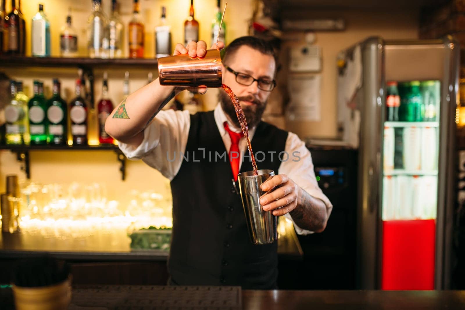 Barkeeper show behind restaurant bar counter. Handsome alcohol beverage preparation