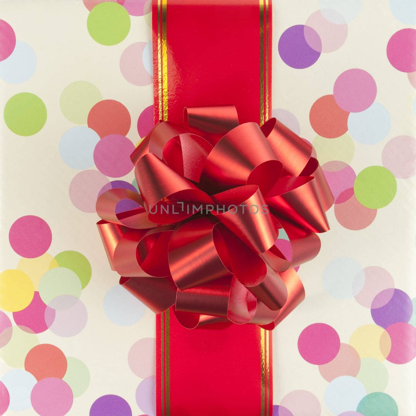 Big red bow and ribbon on color gift paper