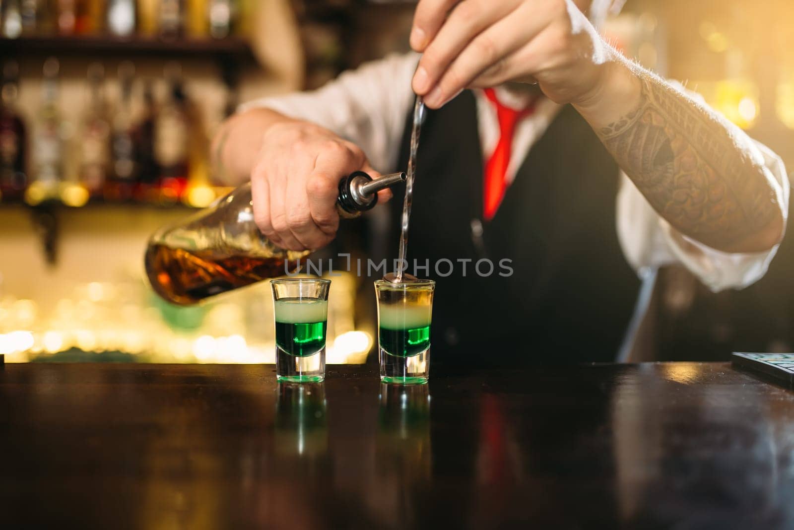 Barman making attractive alcoholic cocktail. Alcohol beverage preparation