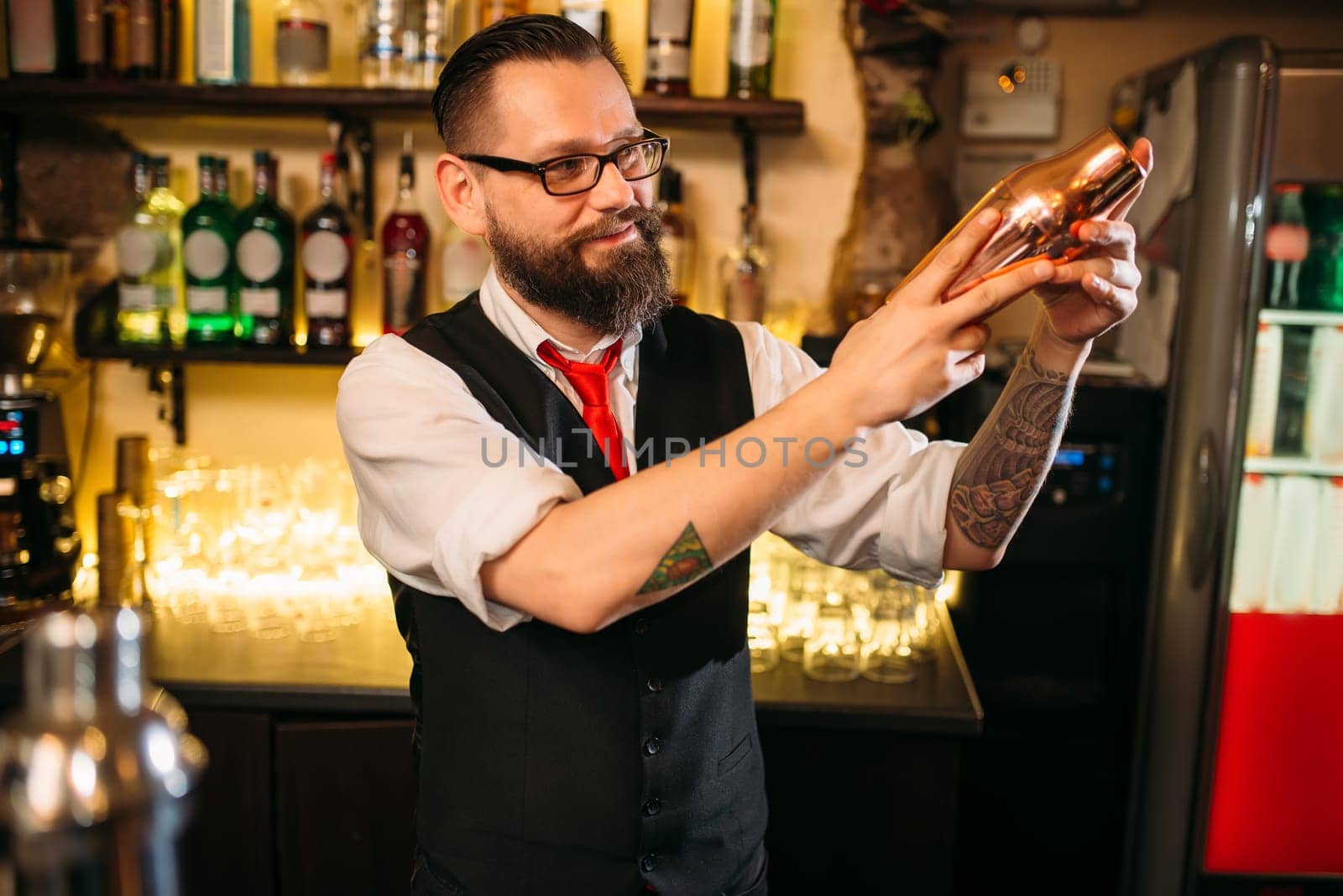 Bartender flair with shaker behind a bar counter. Barman flairing
