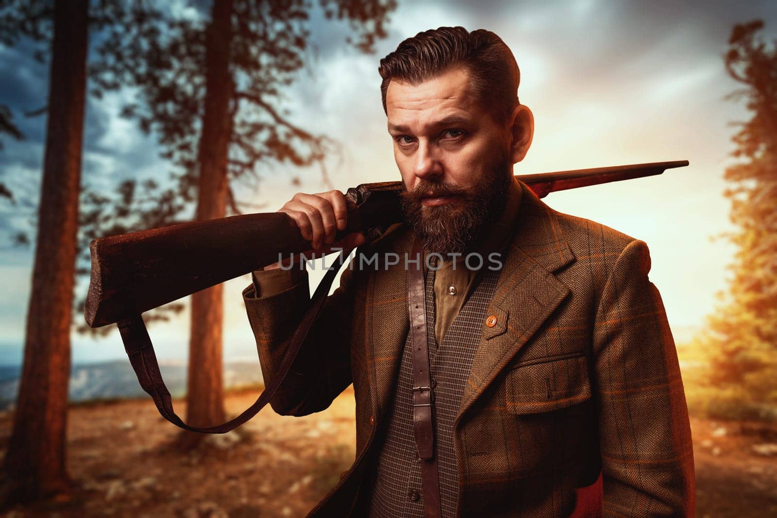 Hunter man in vintage hunting clothing with old gun, forest on background. Hunt lifestyle