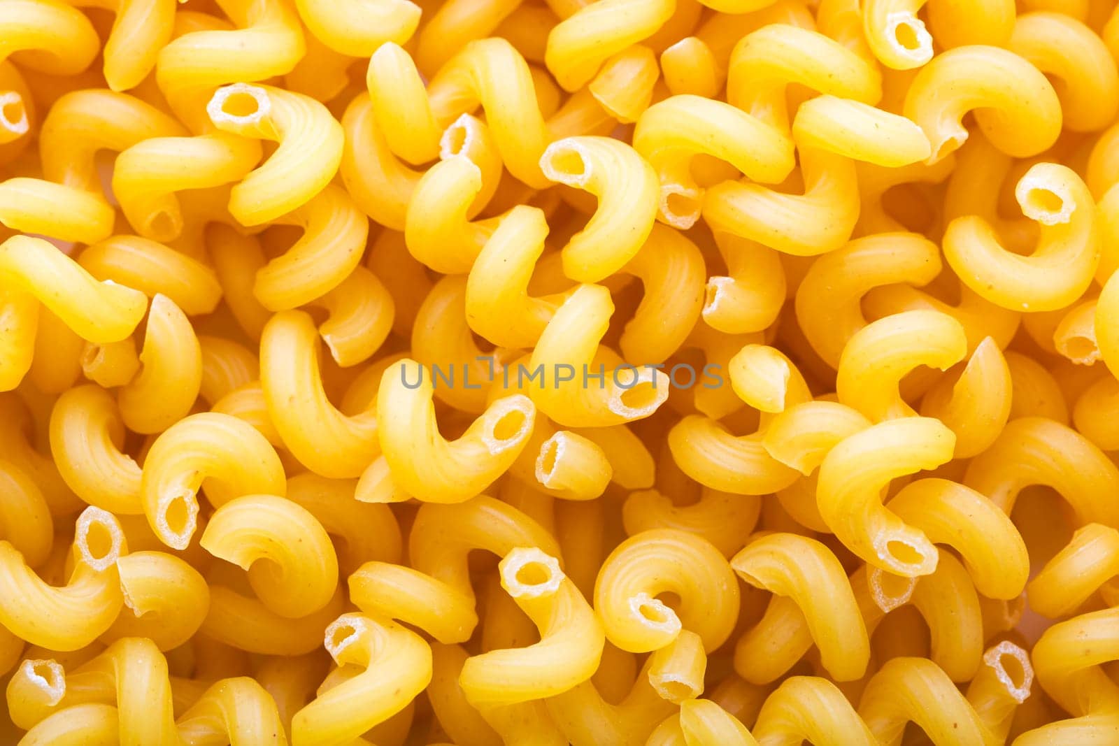 Heap of yellow macaroni closeup. Background