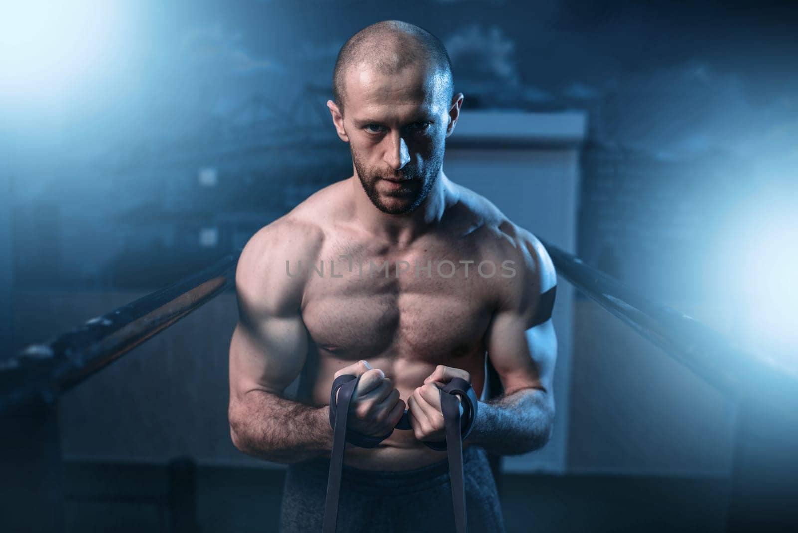 Muscle athlet exercises with elastic band. Active sport lifestyle. Fitness workuot with rubber expander