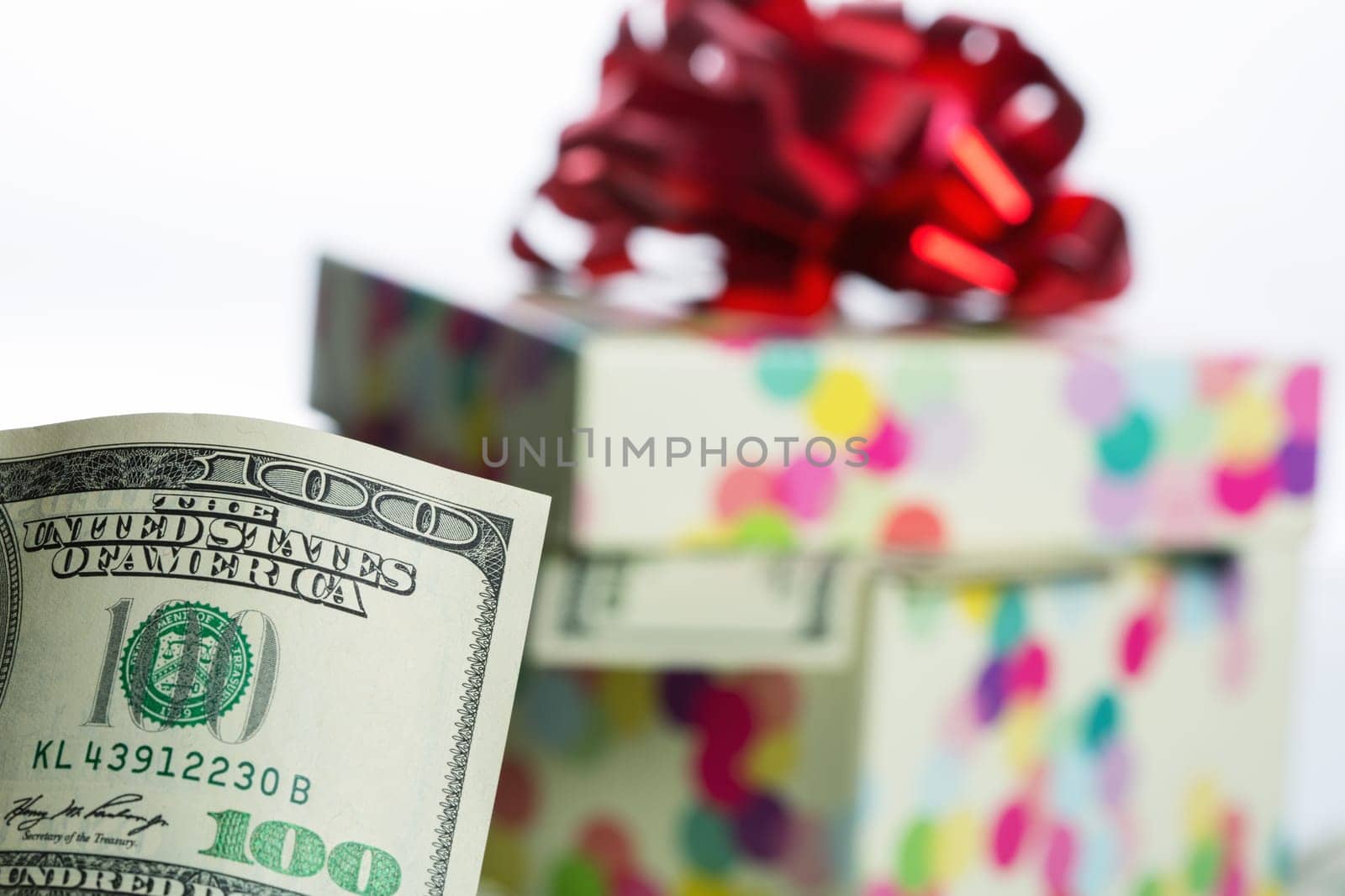 $100 dollar bill against gift box