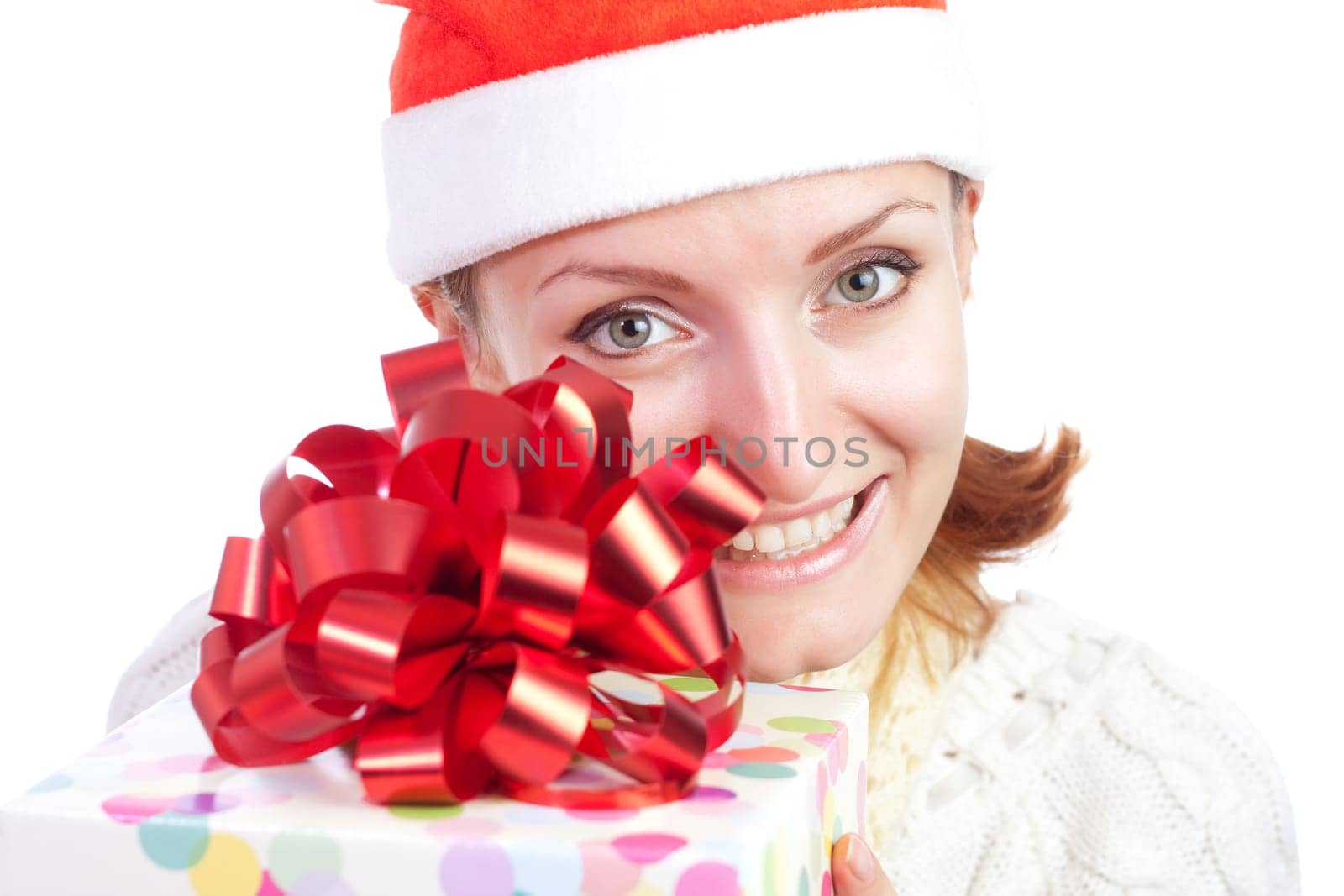 Happy smiling woman in christmas hat with gift. Isolated on white