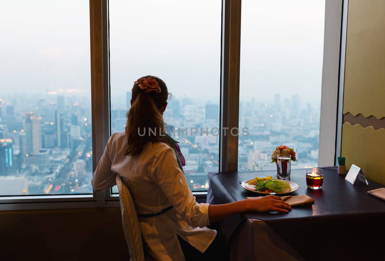 Women sitting in cafe and looking at Bangkok