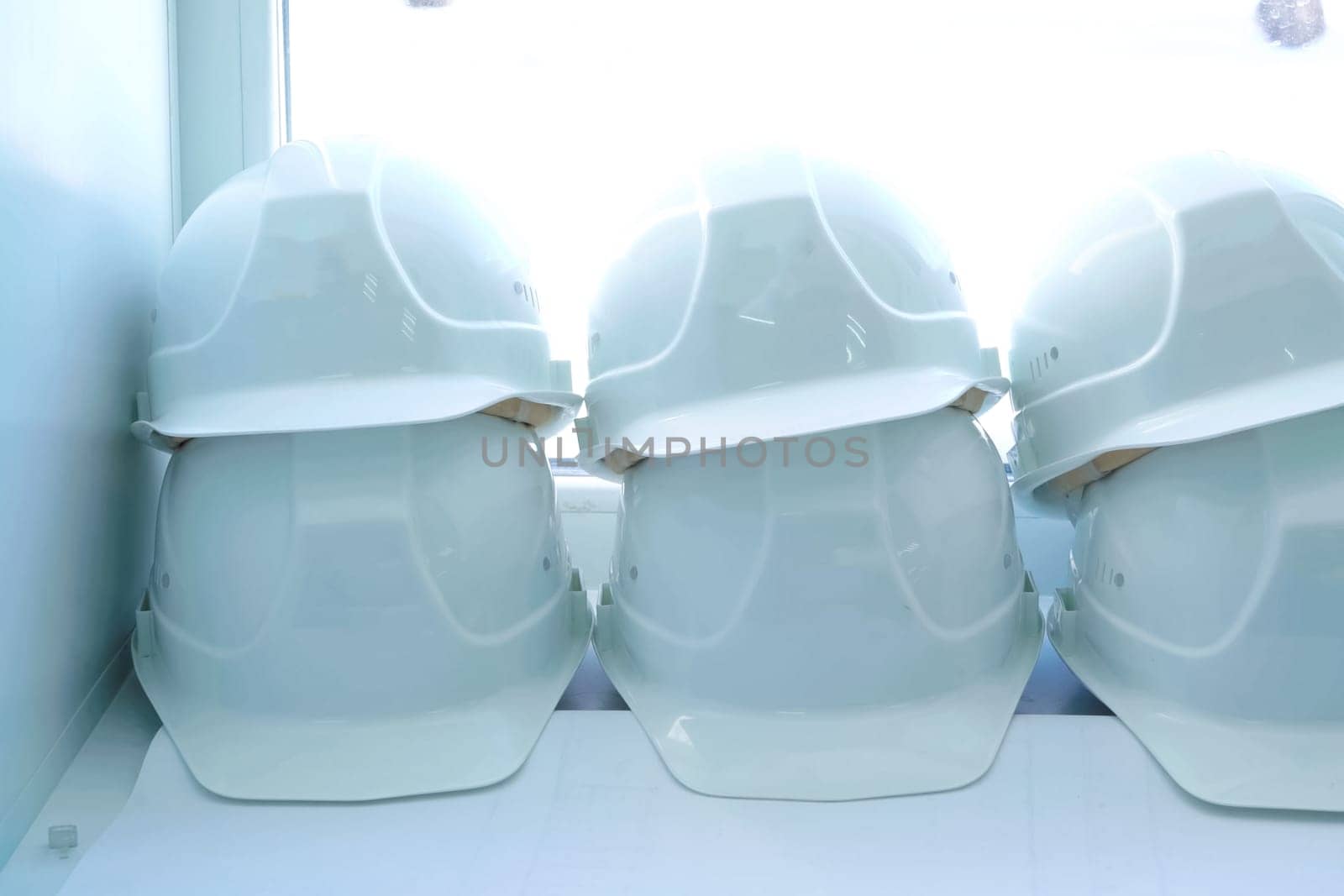 White helmets of workers lie on the windowsill. Protective helmet.