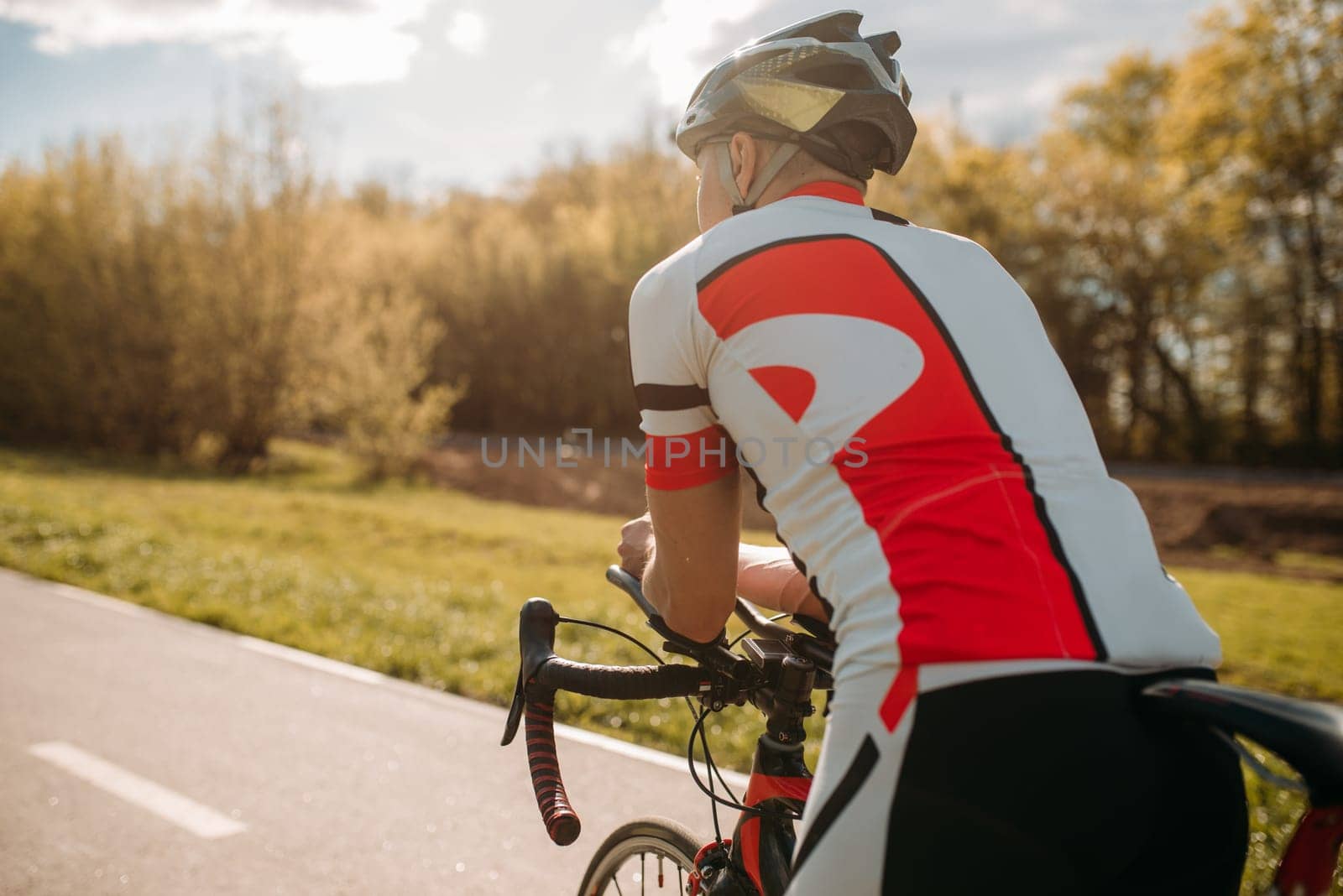 Male bycyclist in sportswear, cycling on bike path. Sportsman rides on bicycle