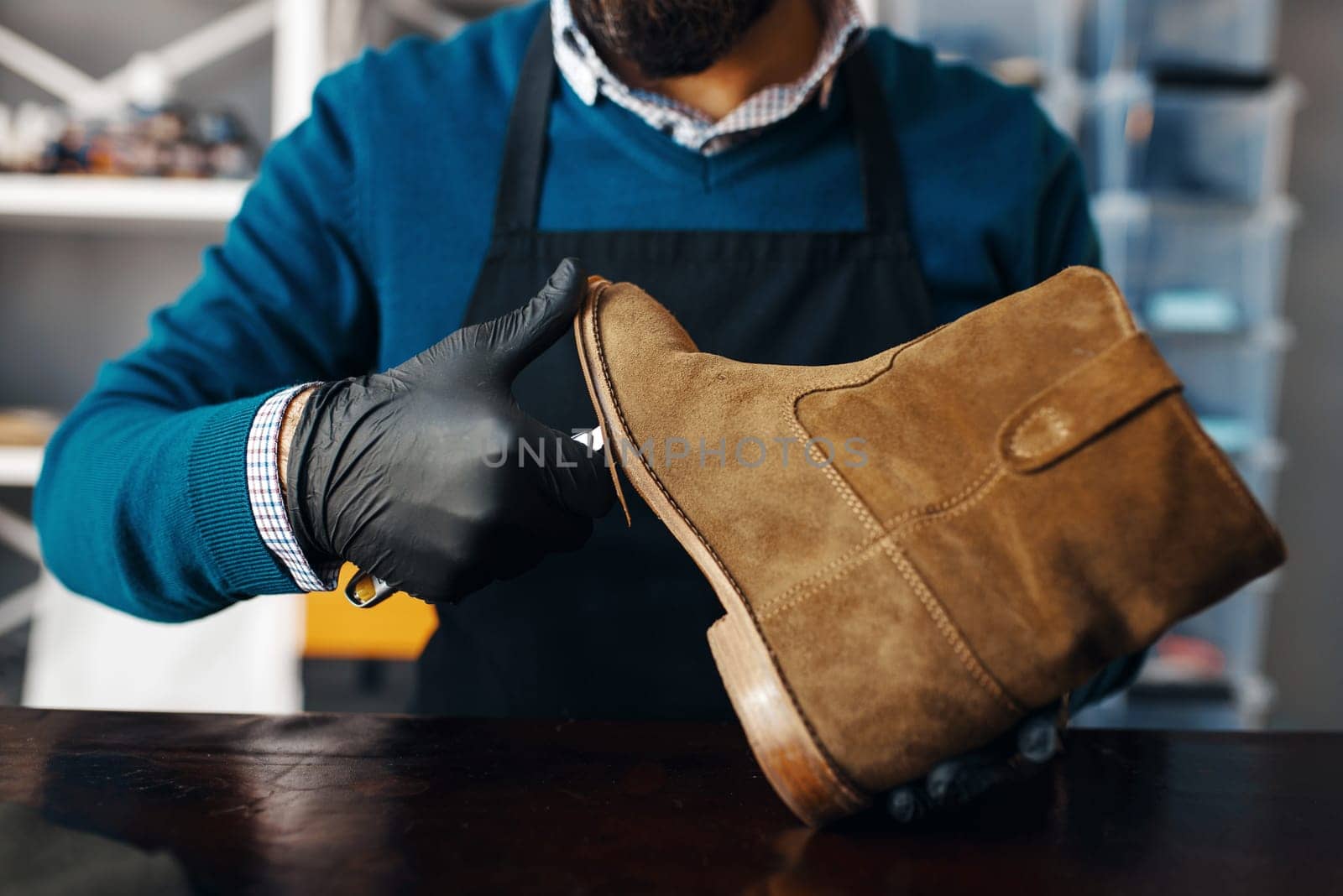 Shoemaker fix the shoe, footwear repair service. Craftsman skill, shoemaking workshop, master works with boots, cobbler job