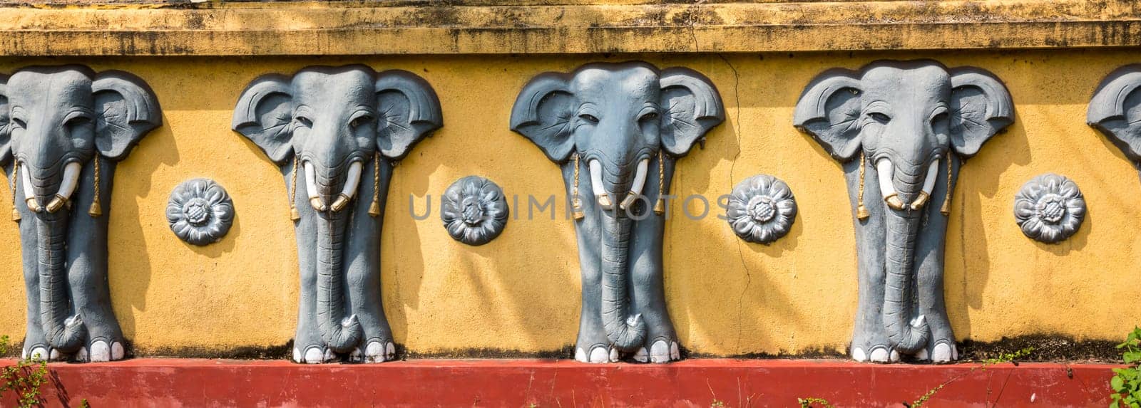 Wall with elephant sculptures in buddha temple, Ceylon attractions, unesco heritage. Asia culture, bubbhism religion
