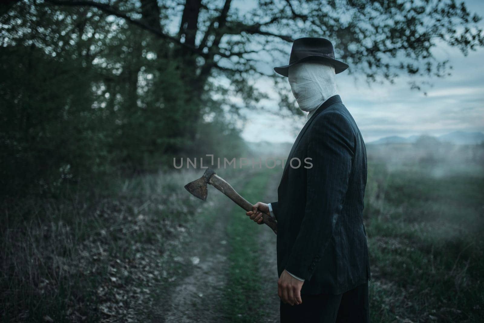 Serial maniac with axe in the forest, face wrapped in bandages, bloody killer concept, crazy murderer, crime and violence horror