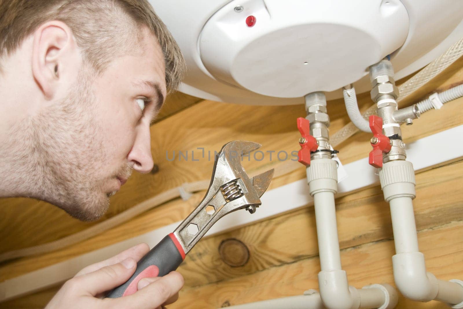Plumber at work. Servicing gas boiler