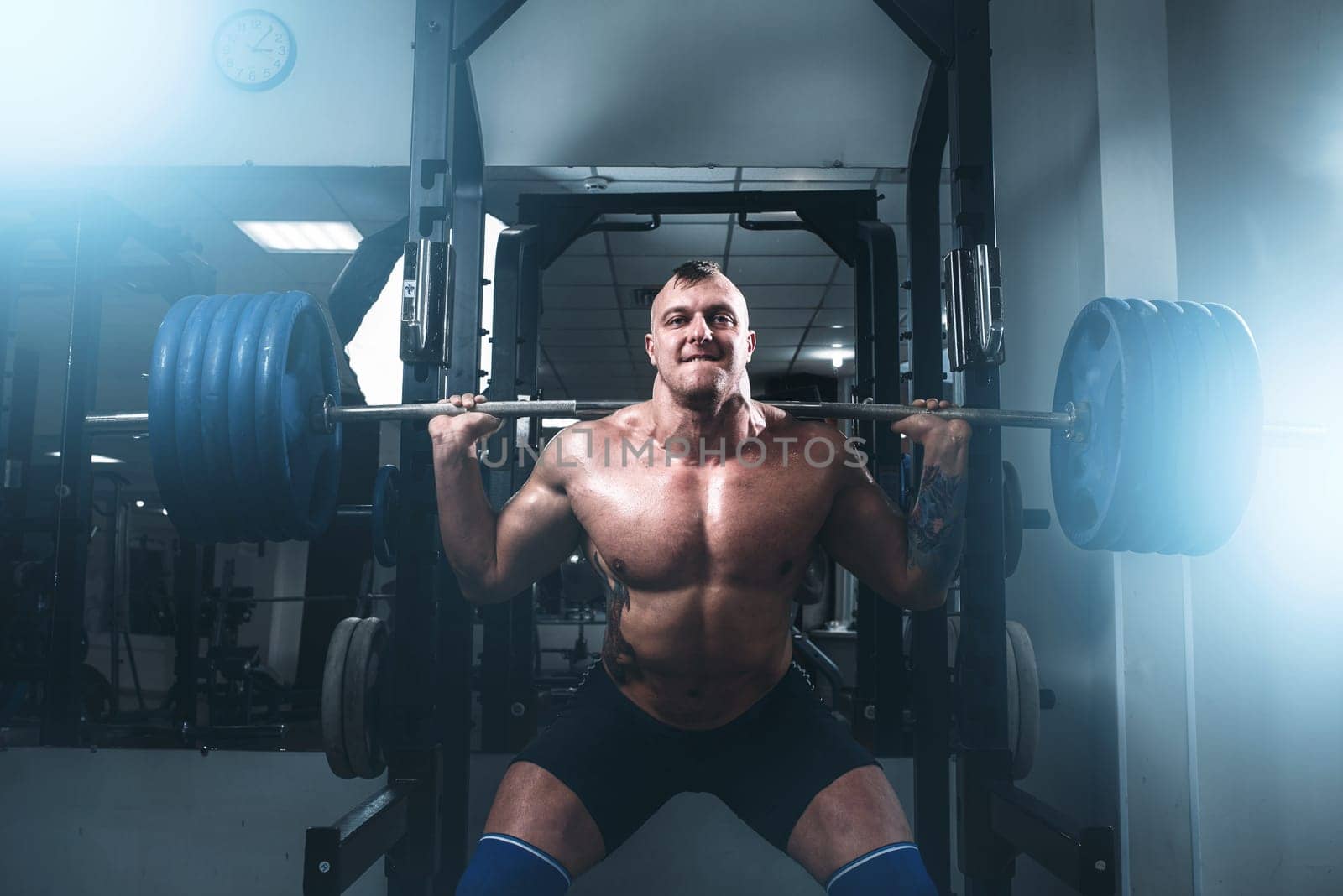 Strong athlete exercise with weight in fit gym. Fitness training with weight. Bodybuilding workout
