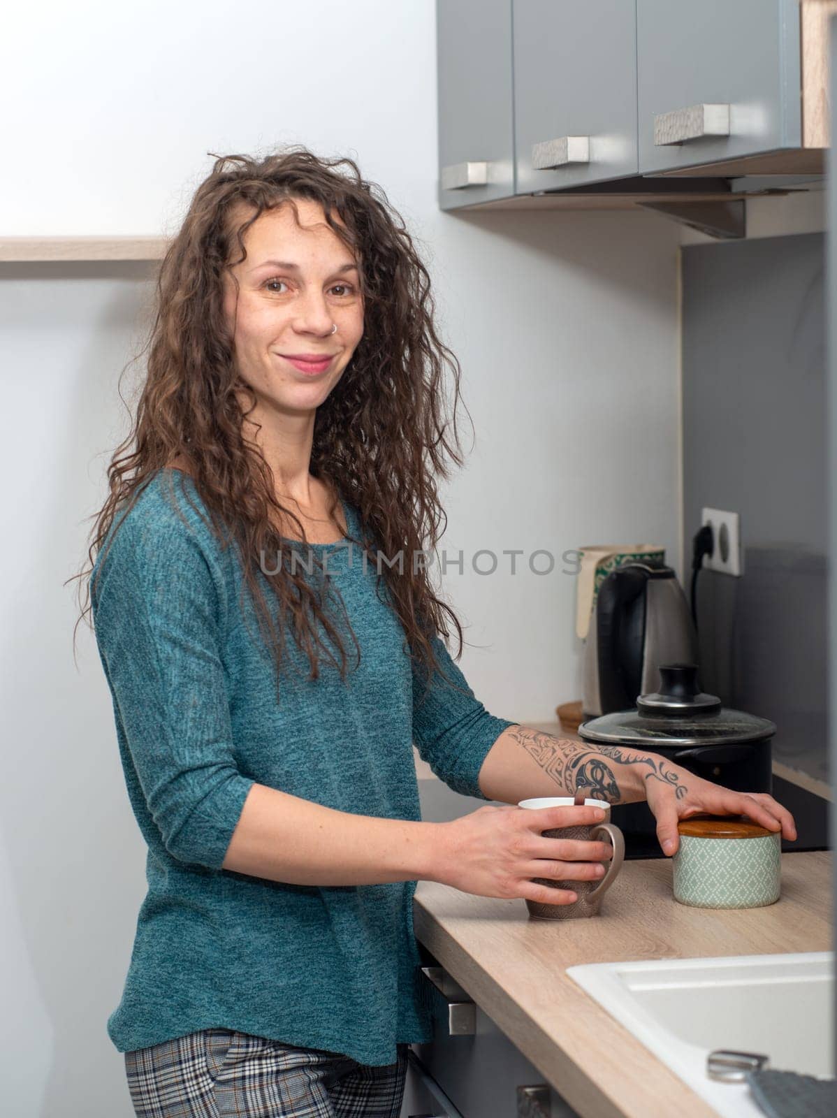 a young woman with long hair is in the kitchen