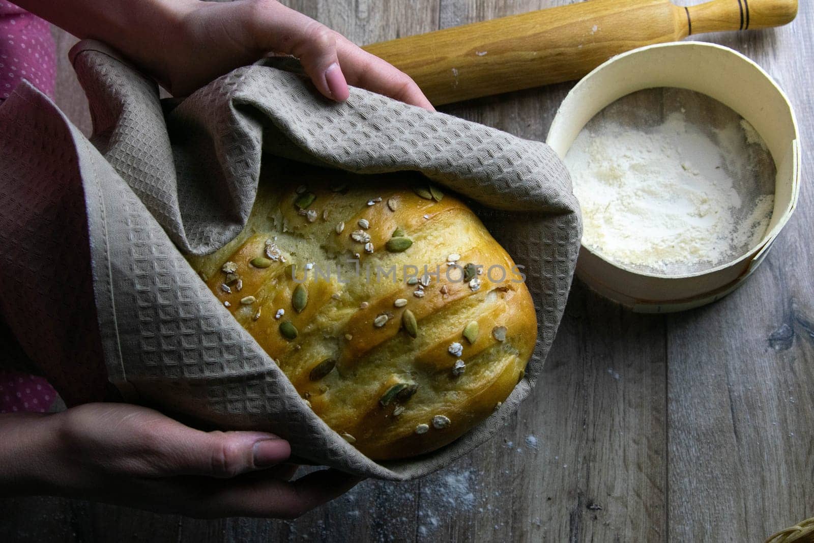Concept shot of breads on the wood table, with egg, flour, seeds and nuts. Front views