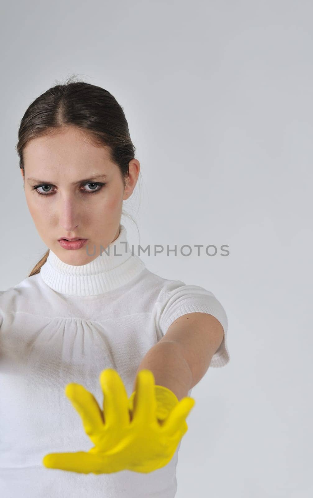 Young woman stretching hands with yellow gloves on