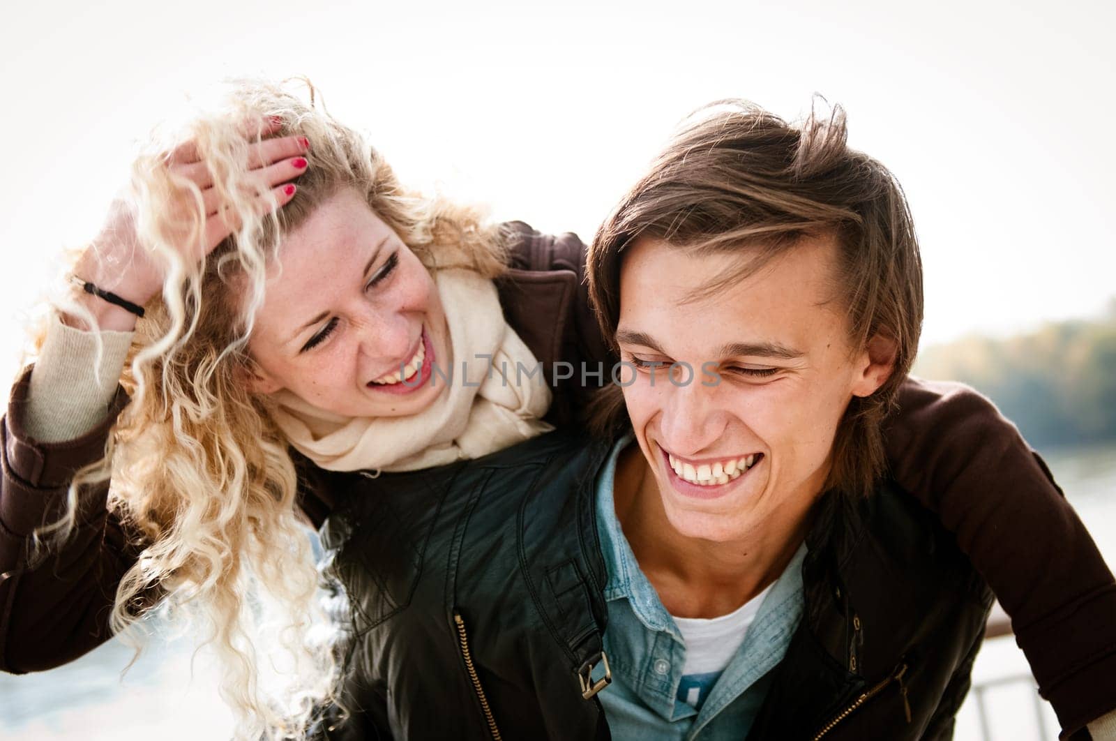 Candid portrait of young couple enjoying life together outdoor