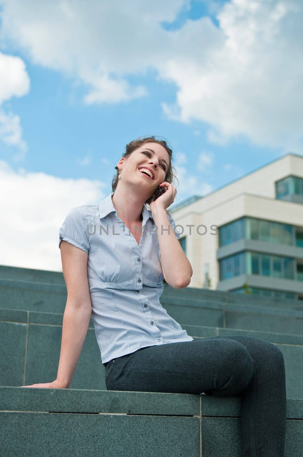 Young beautiful smiling woman calling with mobile phone