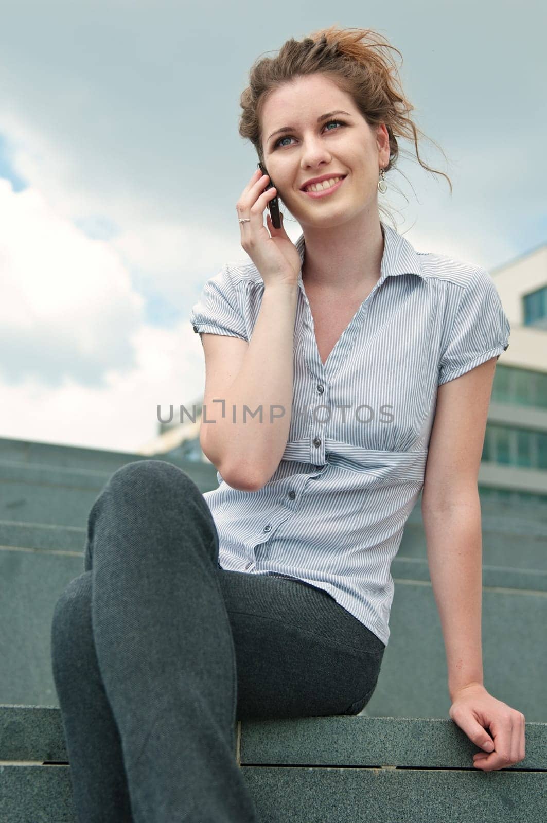 Young beautiful smiling woman calling with mobile phone