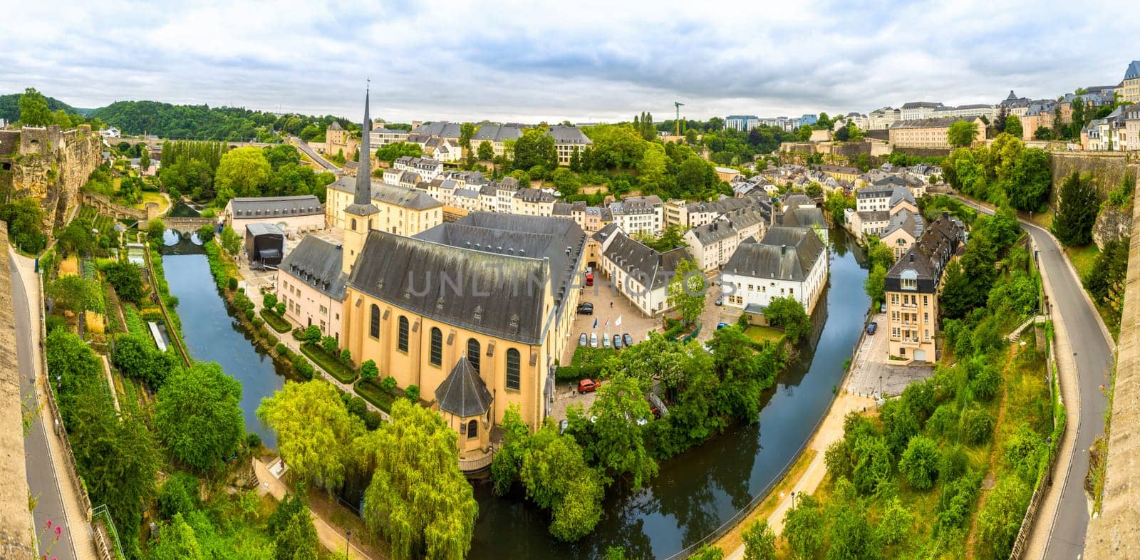 Luxembourg cityscape, ancient church on river, panorama. Old european architecture, medieval stone buildings, benelux country