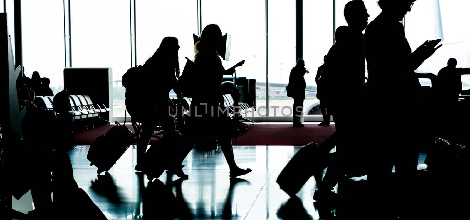 People with luggage go to registration in airport. Travel or tourism concept.