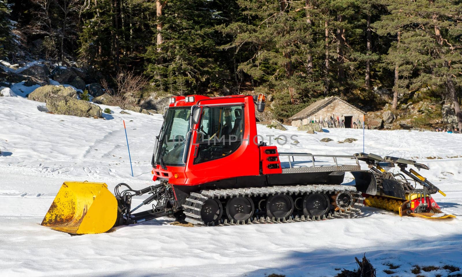 view of a red snow groomer