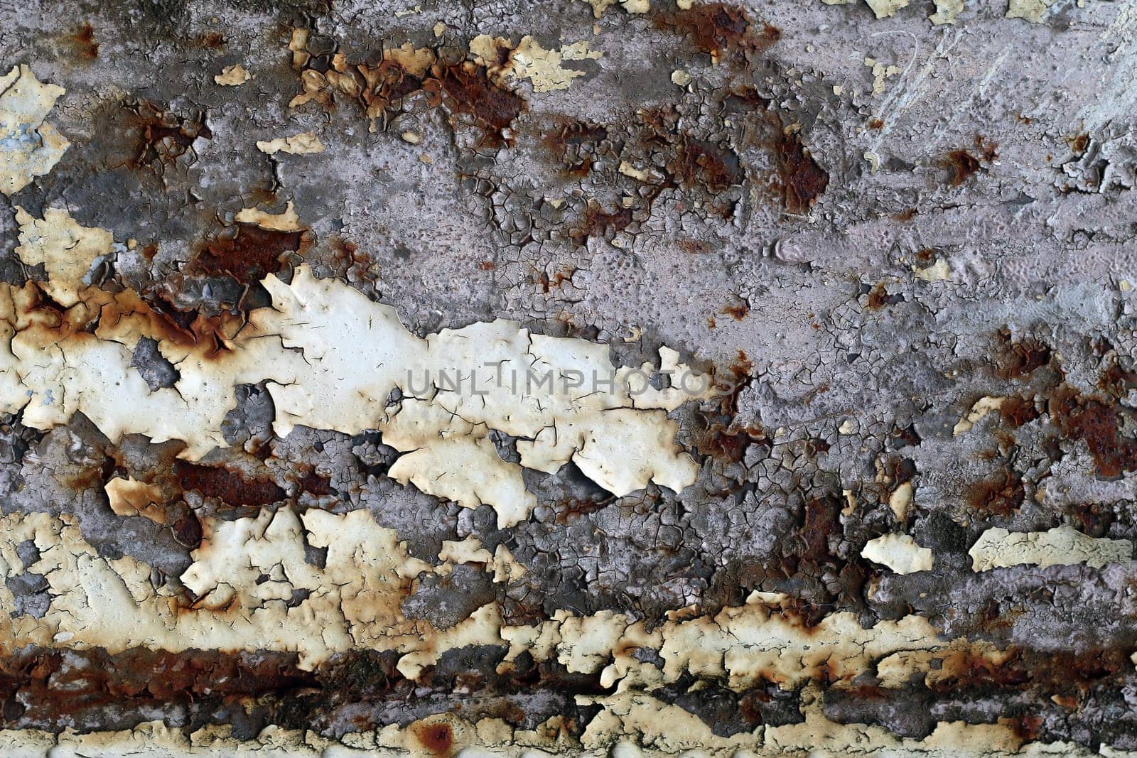 Rusty iron surface with cracks and peeling paint - texture