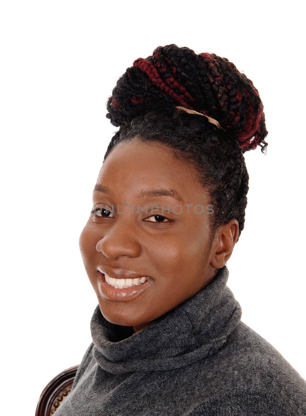 A close up image of an African American woman with her curly hair.as a bun on her head, smiling, isolated for white background.