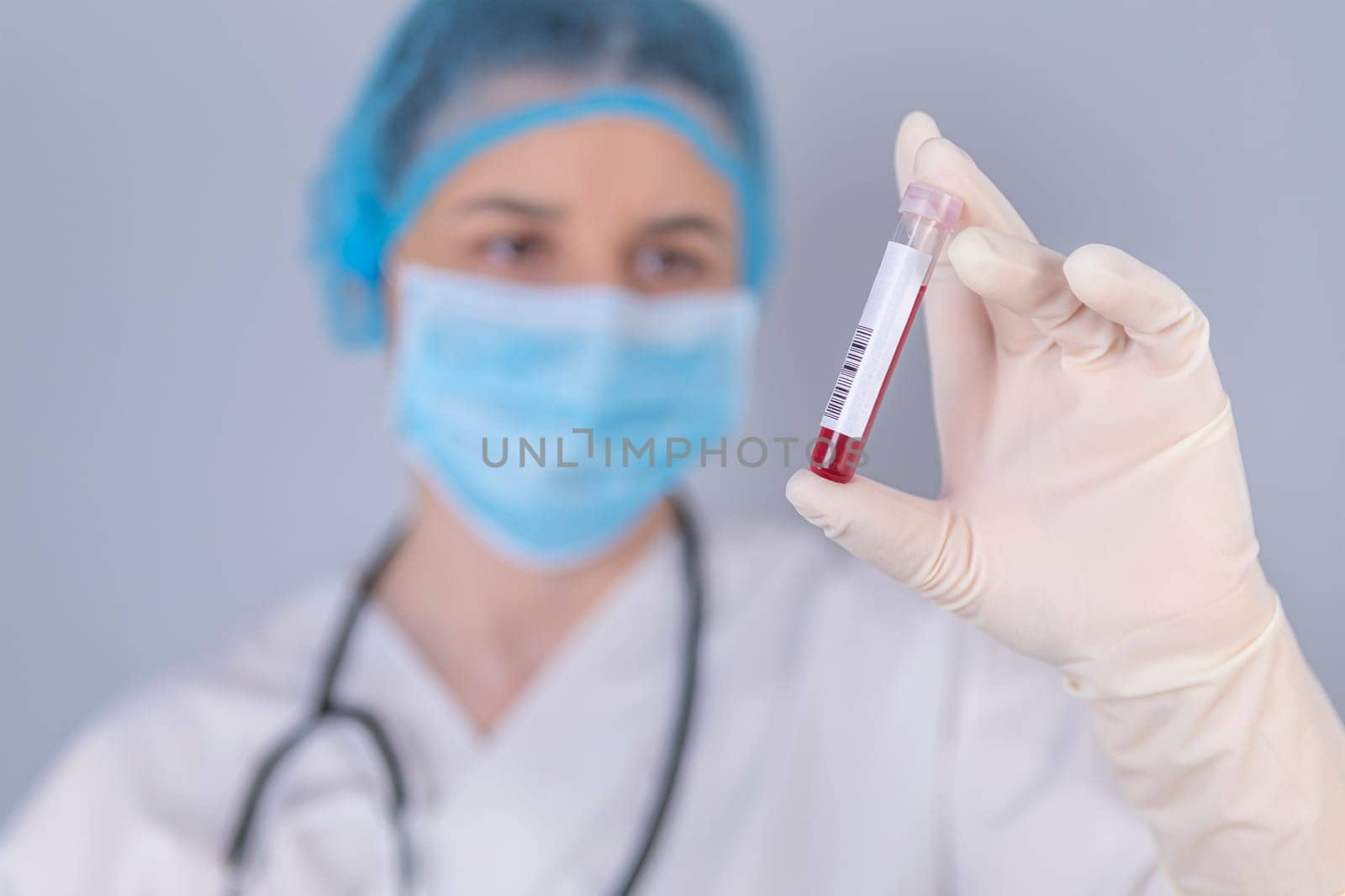 Nurse holding test blood sample. Virus test and research concept. Focus is on blood test tube.