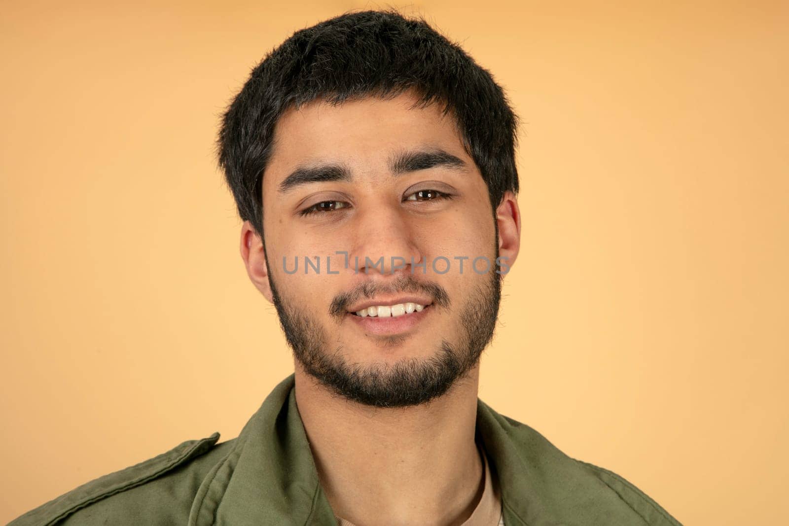 Beautiful black haired man on beige background