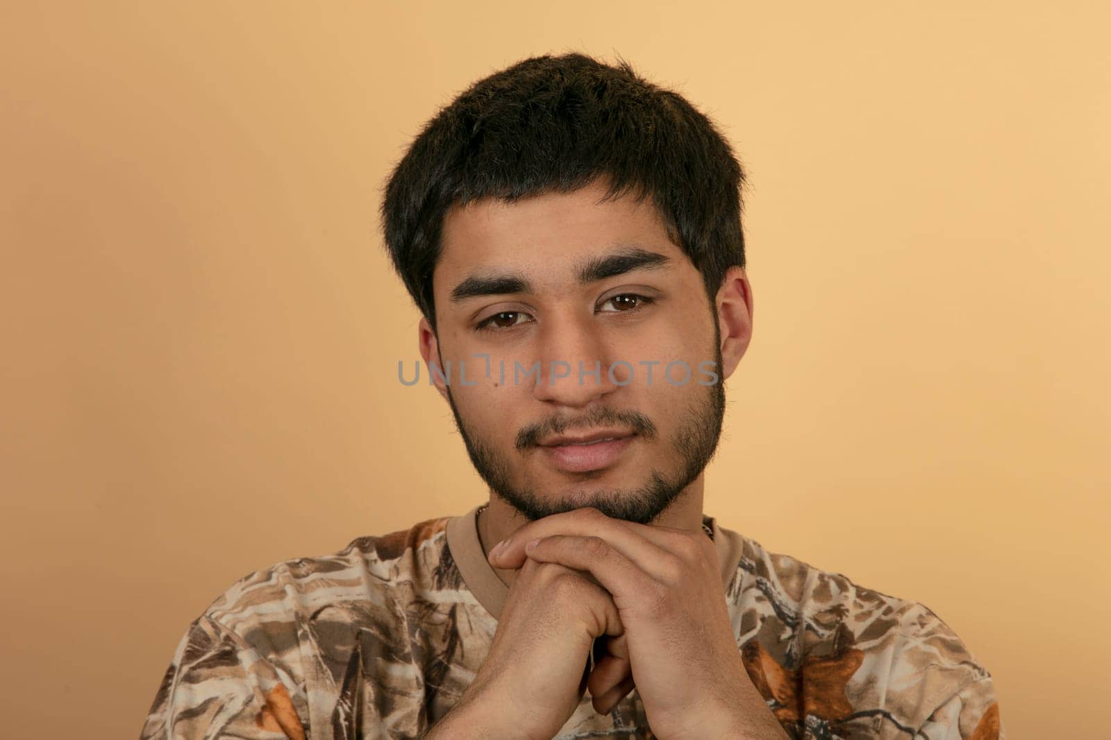 Friendly young Man on beige Background
