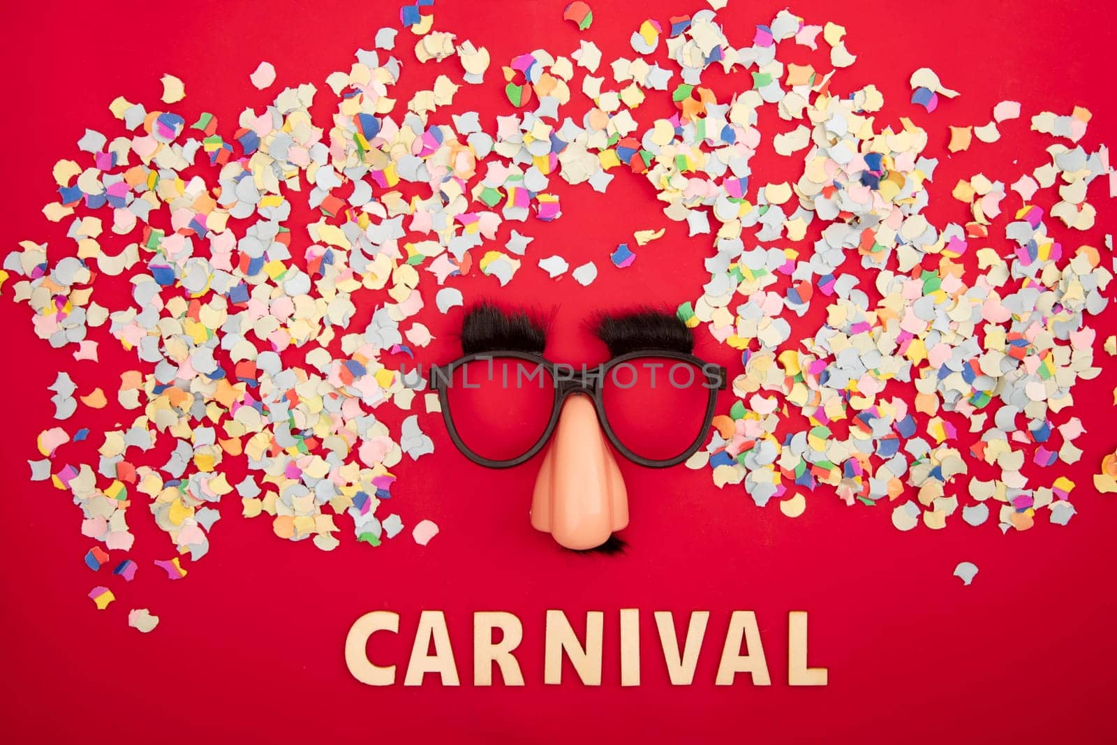 Funny mask surround colorful confetti on red background