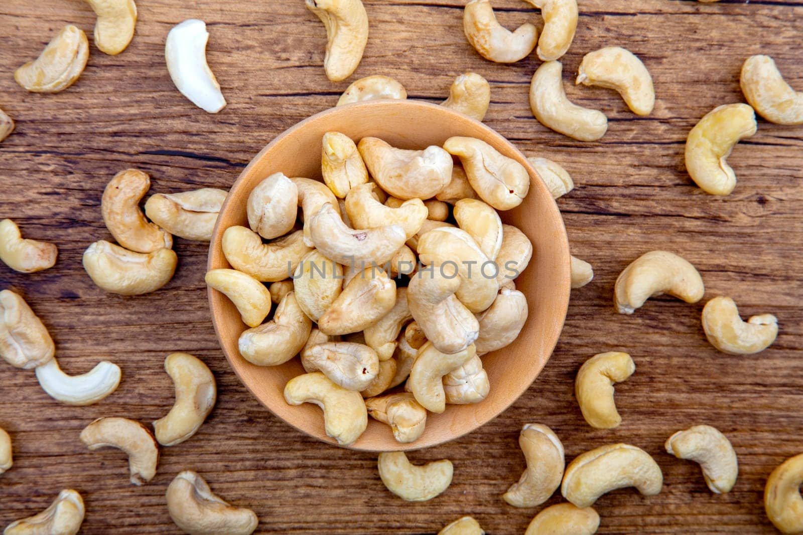 Cashew Nuts in wooden Bowl on brown background