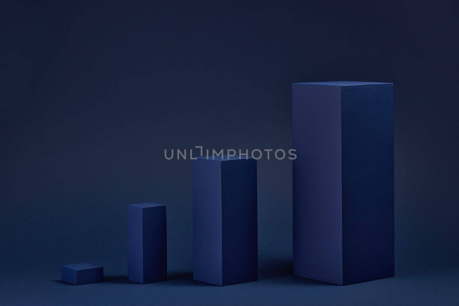 Abstract composition with geometric figures. Set of rectangular parallelepipedes on a blue background. Abstract background with copy space for design of advertising, engineering draft, web design.