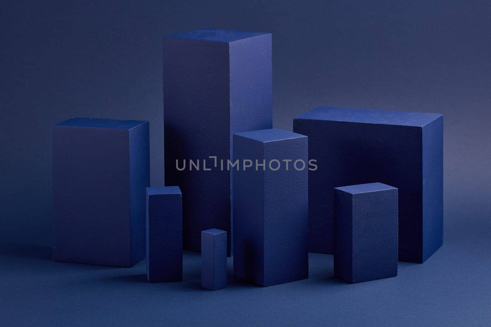 Abstract composition with geometric figures. Set of rectangular parallelepipedes on a blue background. Abstract background with copy space for design of advertising, engineering draft, web design.