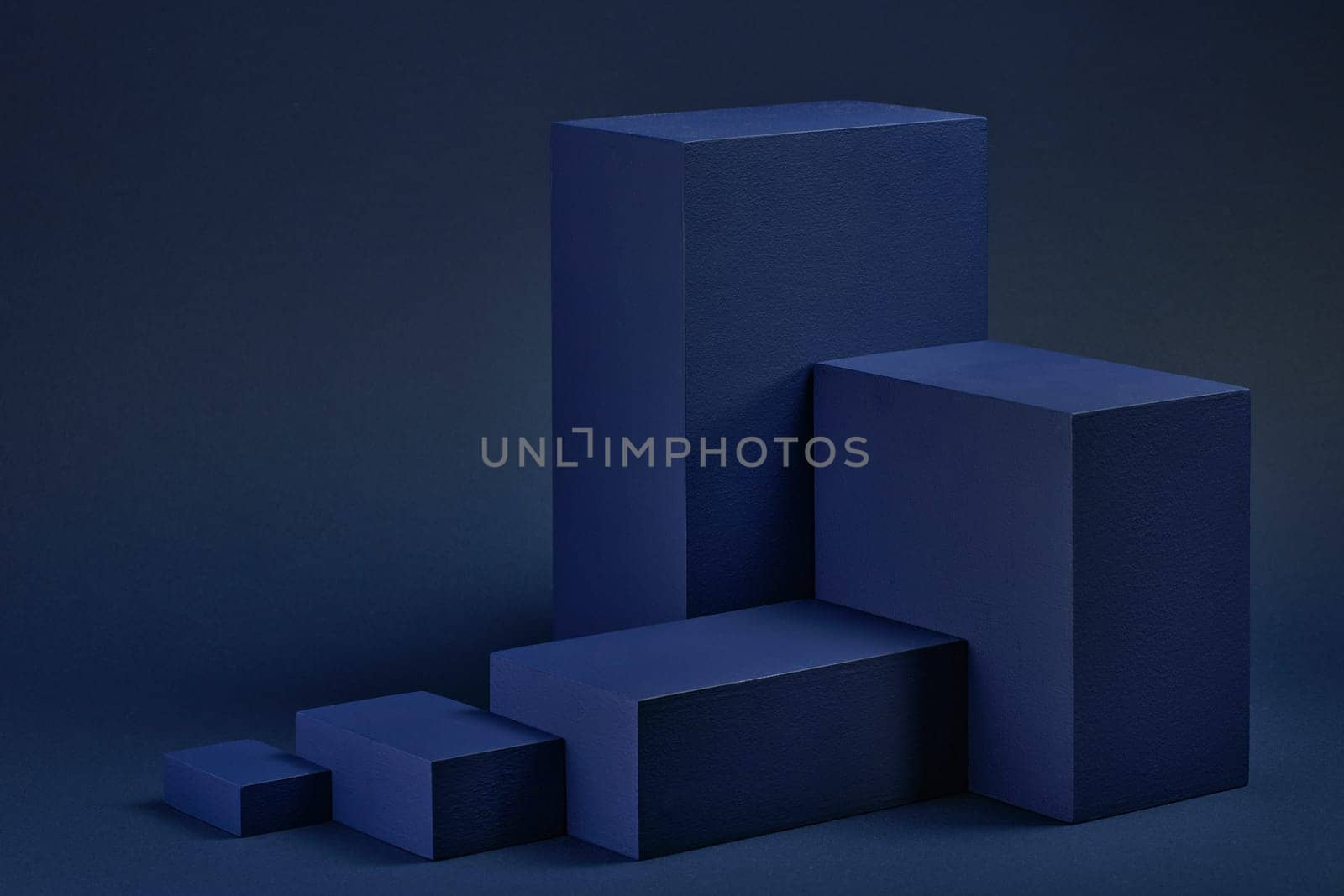 Abstract composition with geometric figures. Set of rectangular parallelepipedes on a blue background. Abstract background with copy space for design of advertising, engineering draft, web design.