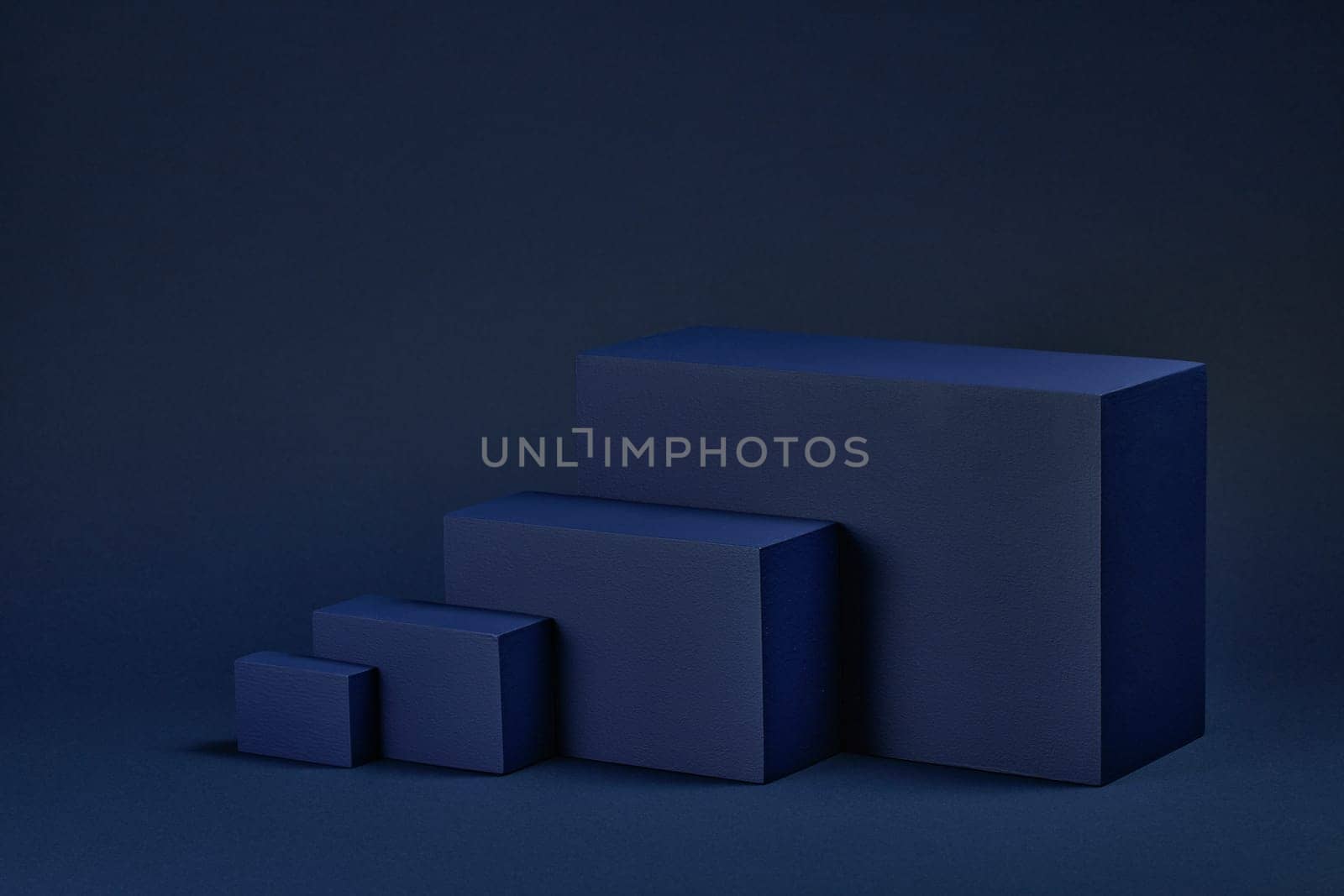 Abstract composition with geometric figures. Set of rectangular parallelepipedes on a blue background. Abstract background with copy space for design of advertising, engineering draft, web design.