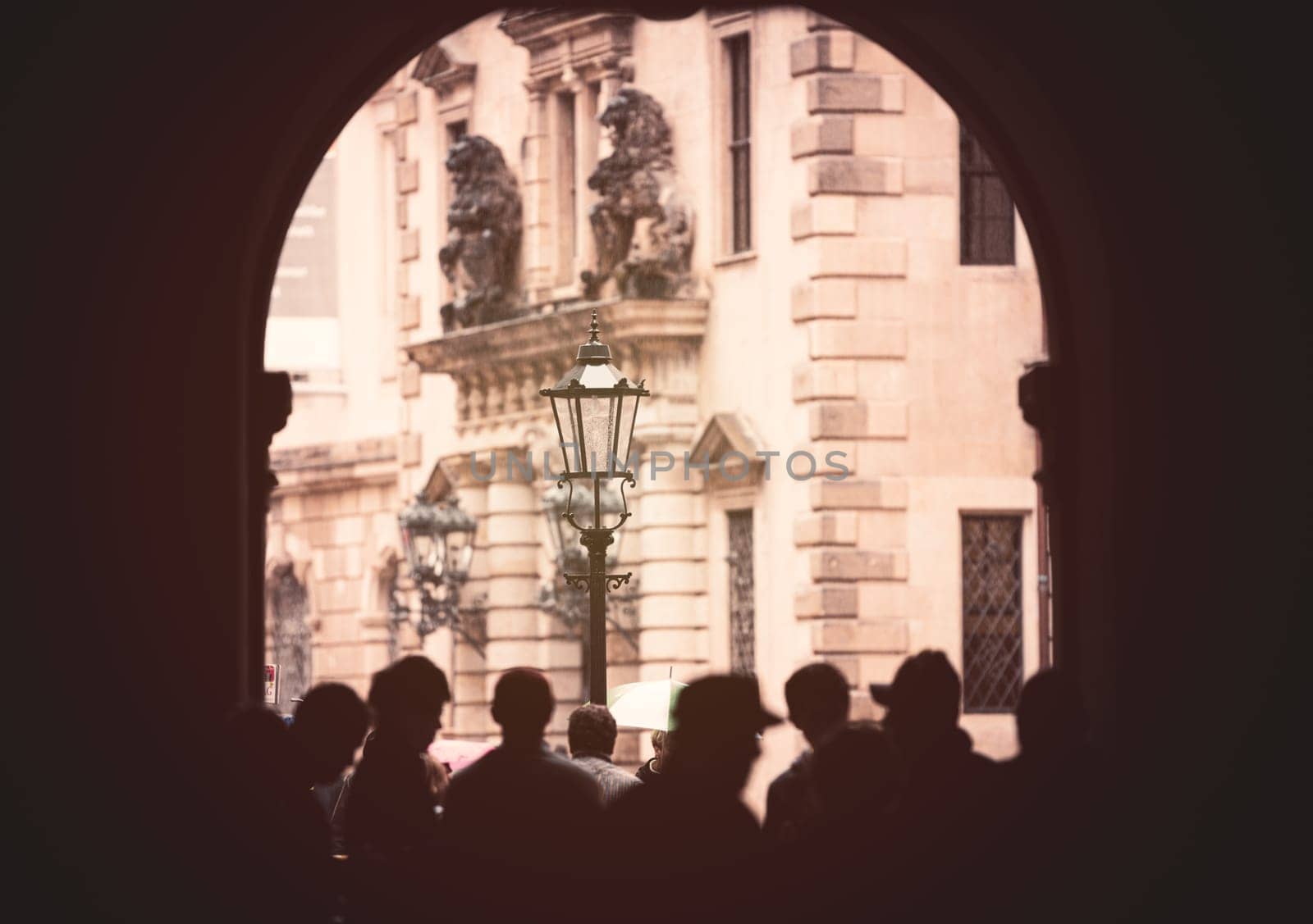People cover from rain in arch of building in Dresden, Germany, Europe. Travel and architecture.