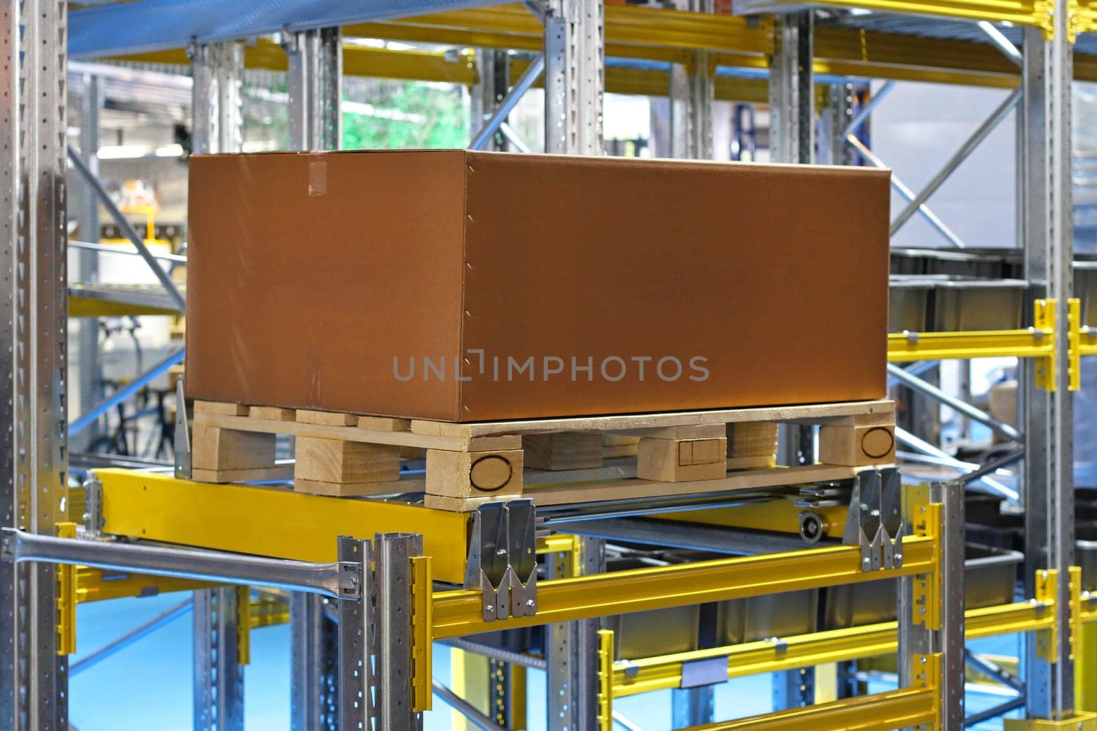 Cardboard box and pallet at warehouse shelf