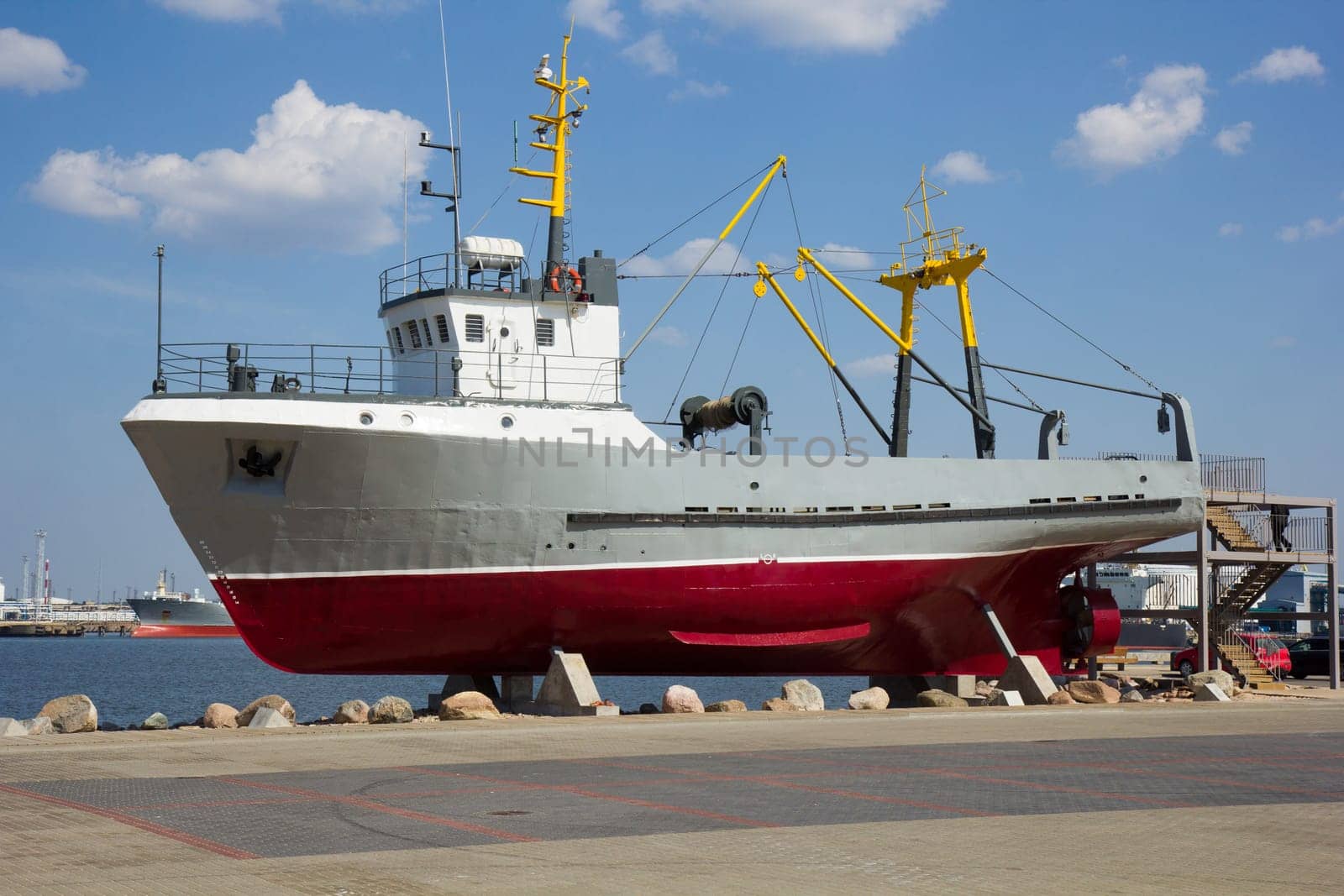 old fishing boat on postament as tourist attraction in Latvia, Ventspils