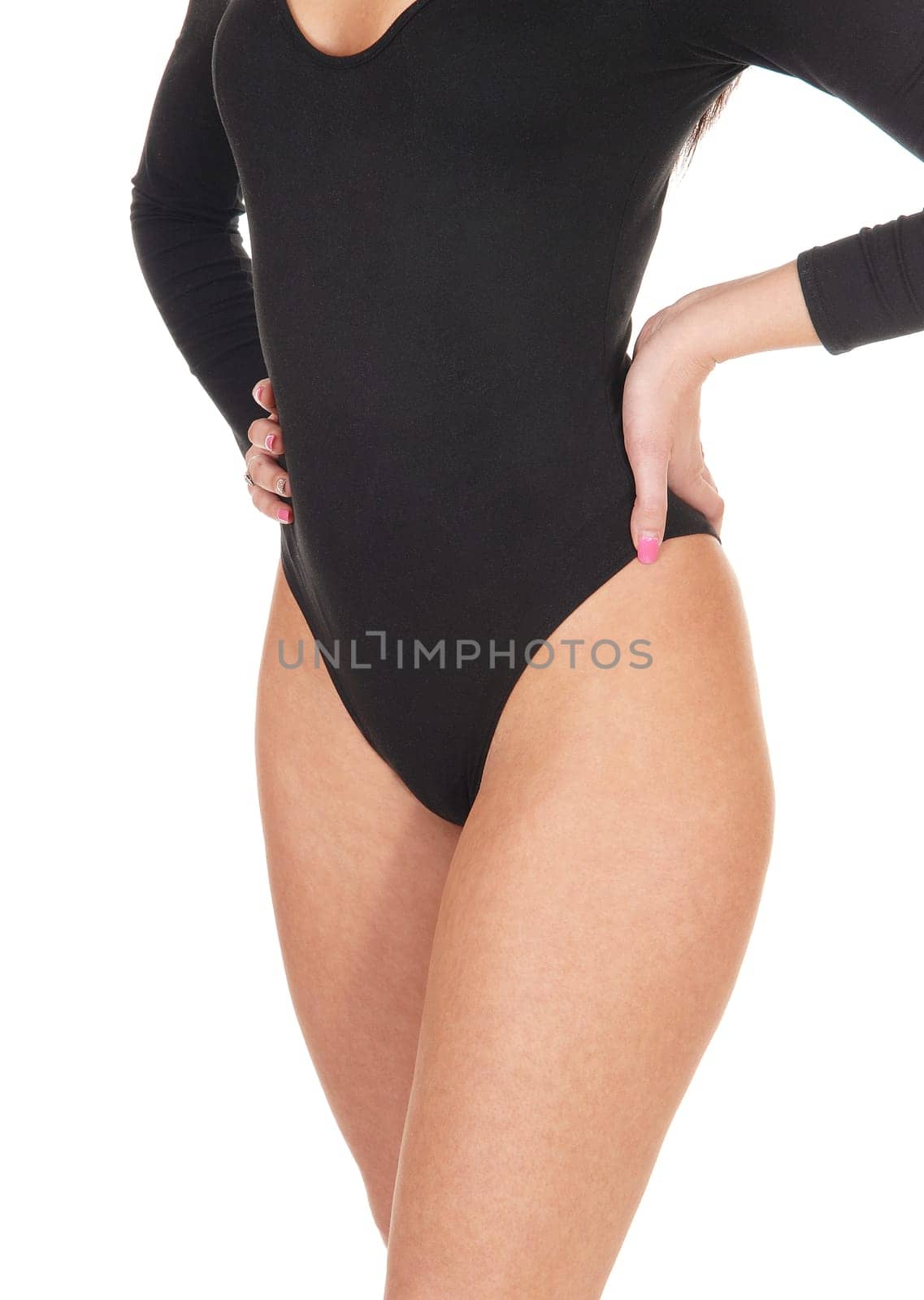 A close up image of a slim young woman in a black body suit standing.from the front with her hands on her hip, isolated for white background.