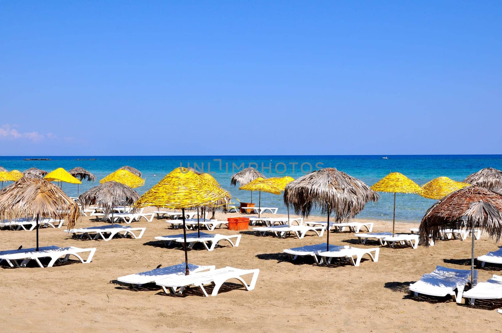 Handmade palm leaf and cane umbrellas on a beautiful Cyprus beach
