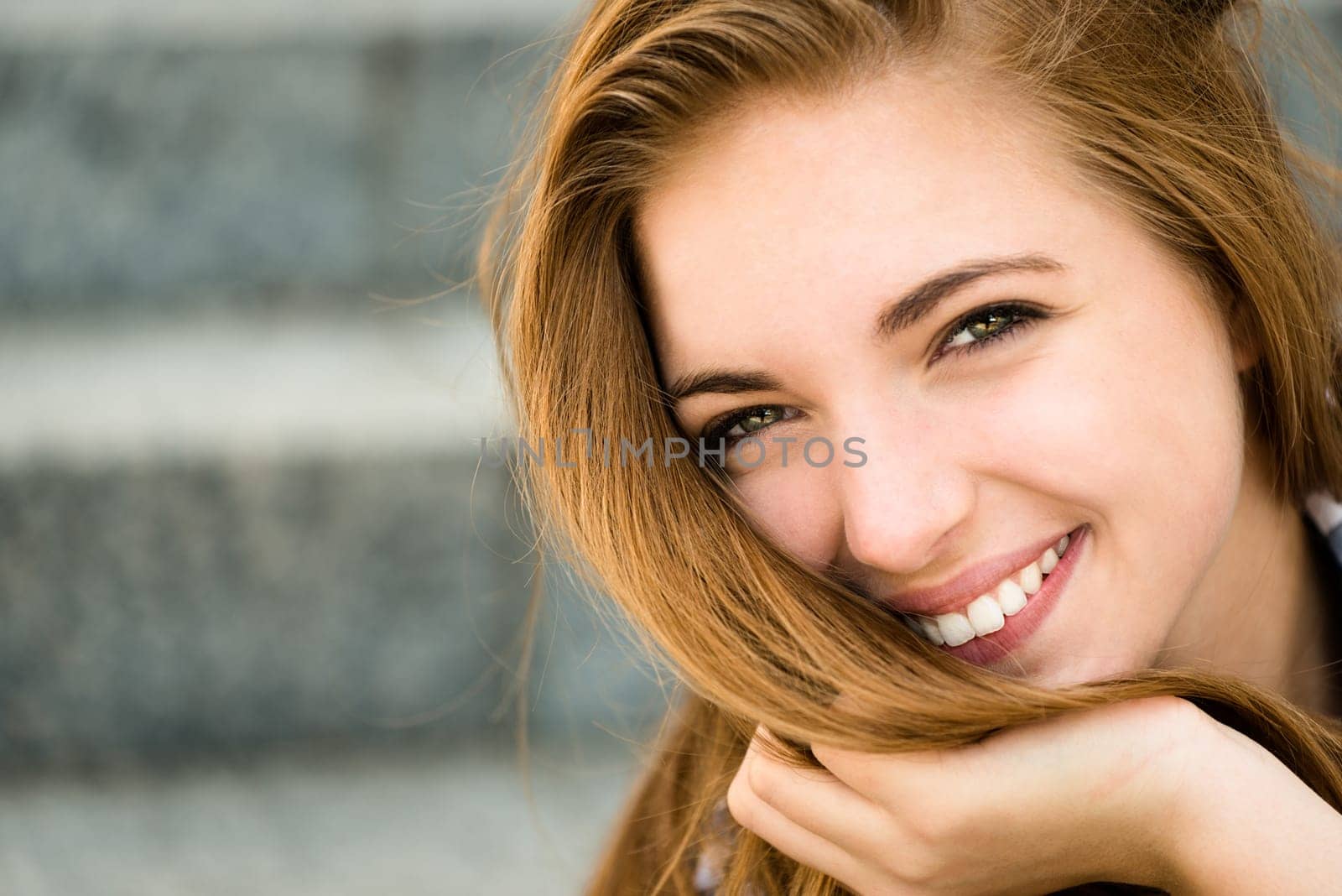 Teenager portrait - smiling girl outdoor in urban environment
