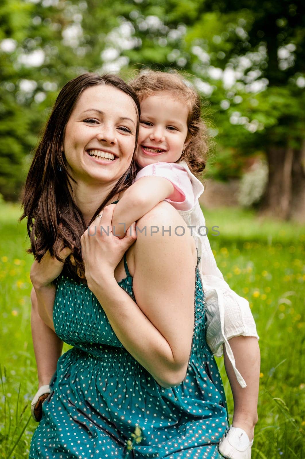 Small girl enjoying life with her mother outdoor - lifestyle portrait