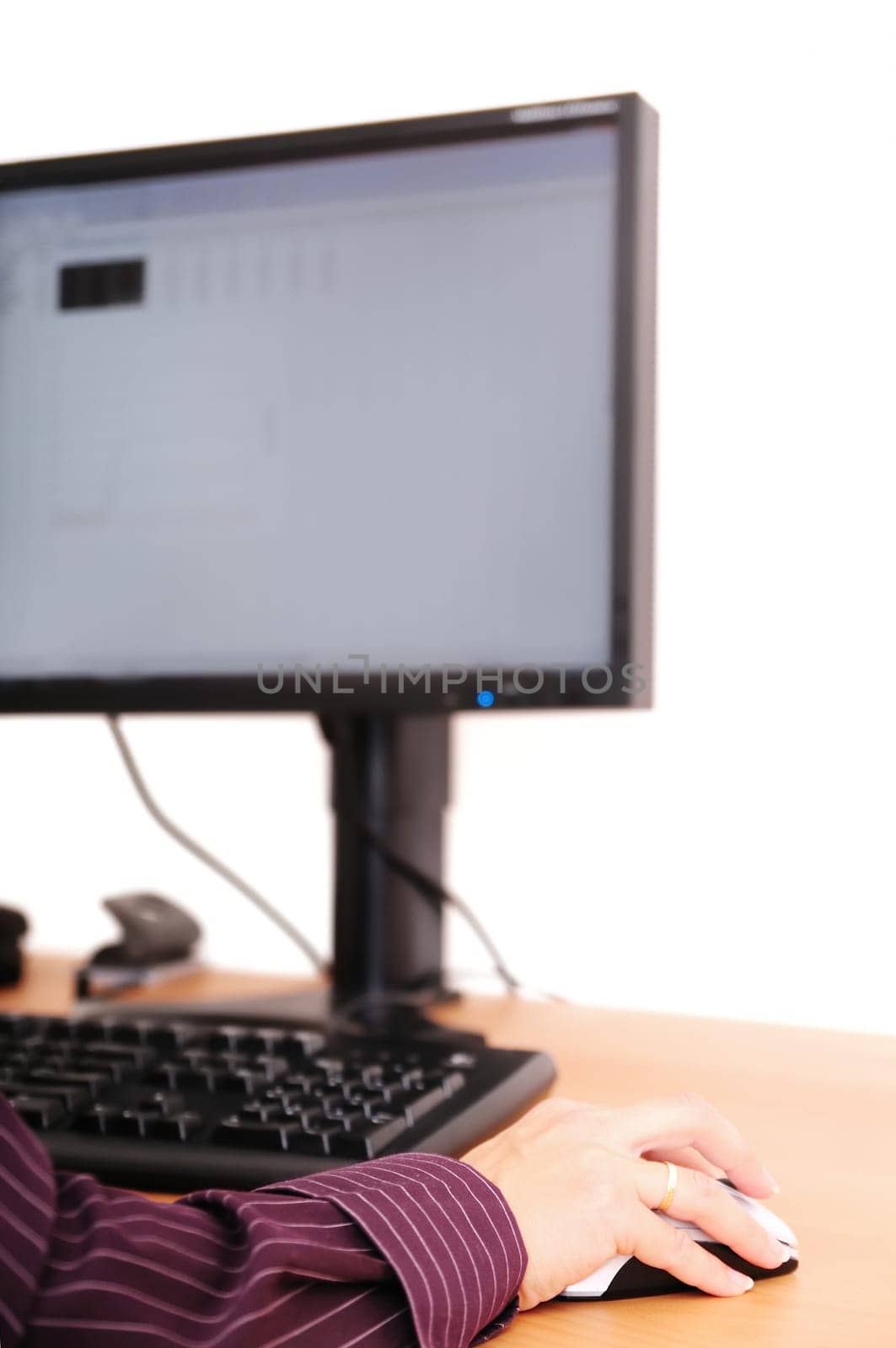 Work with computer - detail. Hand on mouse with monitor in background