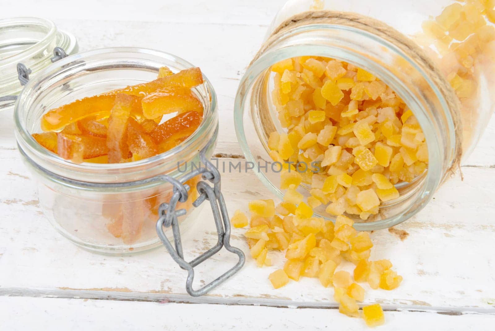 candied oranges cut into pieces on the white wooden table