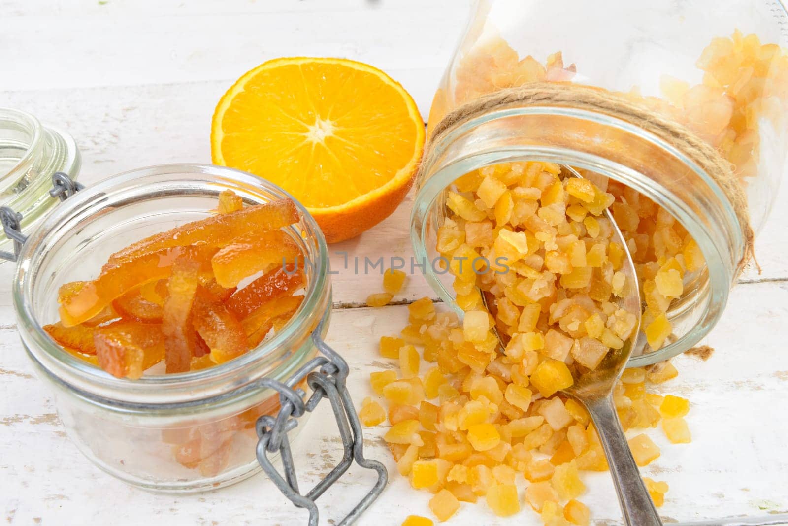 candied oranges cut into pieces on the white wooden table