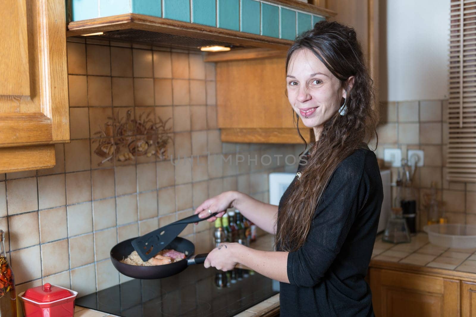 a young woman making dinner in the kitchen