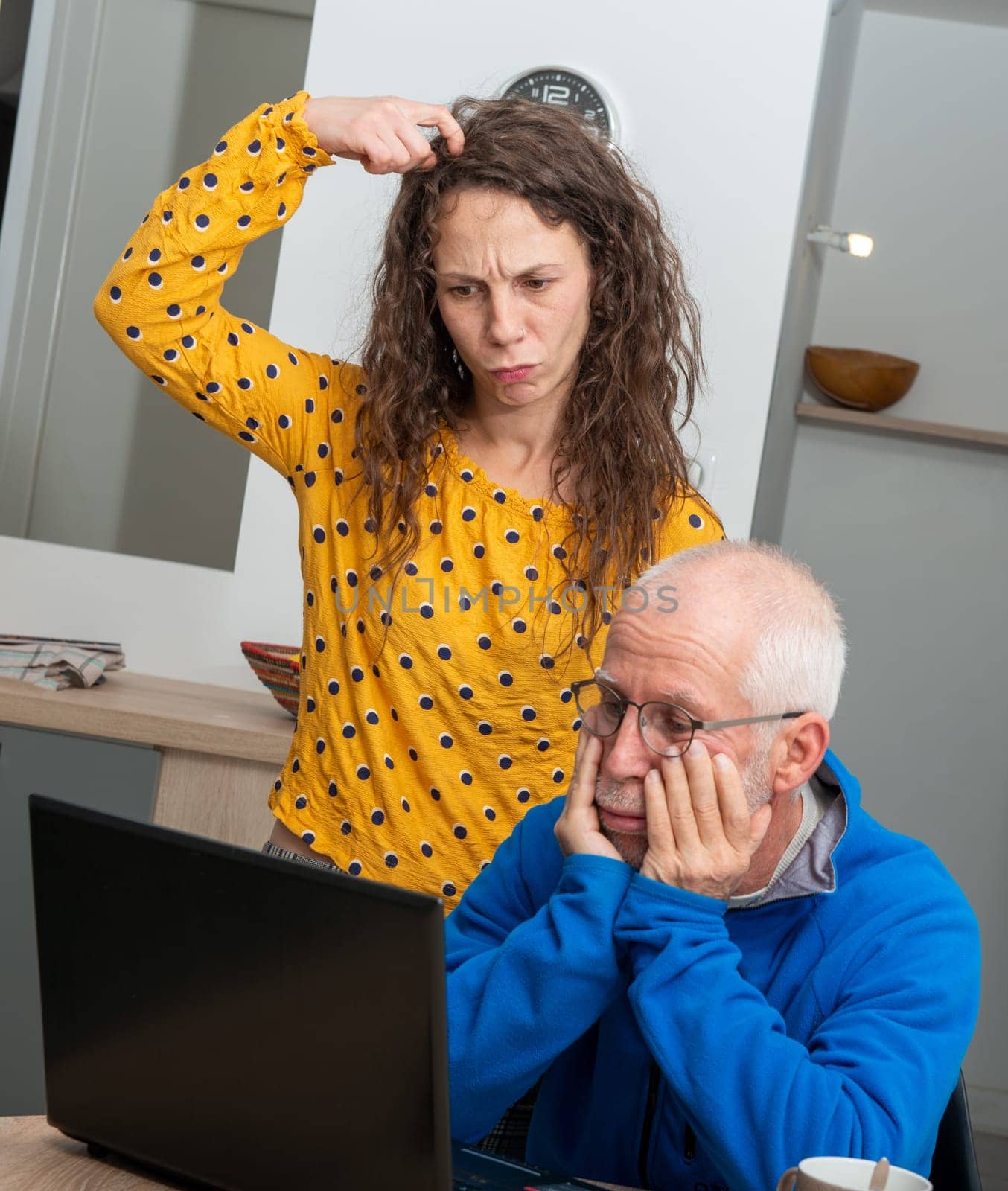 Young woman and senior man have problem with a laptop computer