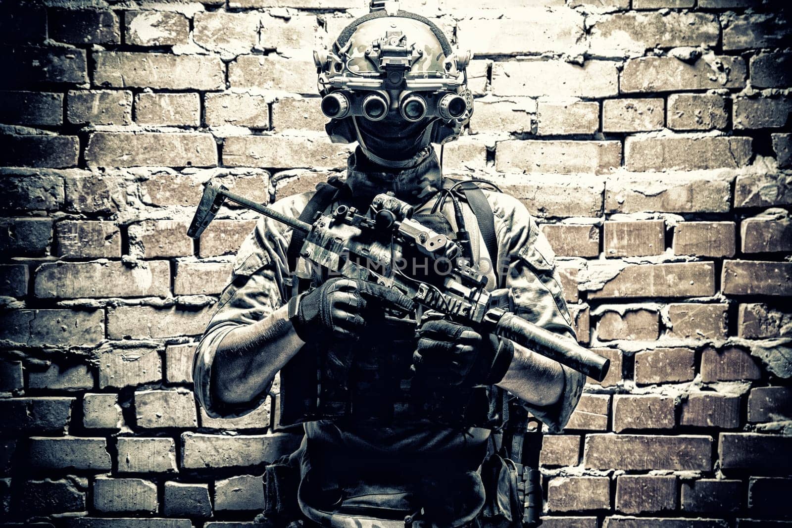 Army special forces tactical group fighter in cqb mission, using radio headset, looking through four lens night-vision, thermal imaging device on helmet, armed small submachine gun with silencer